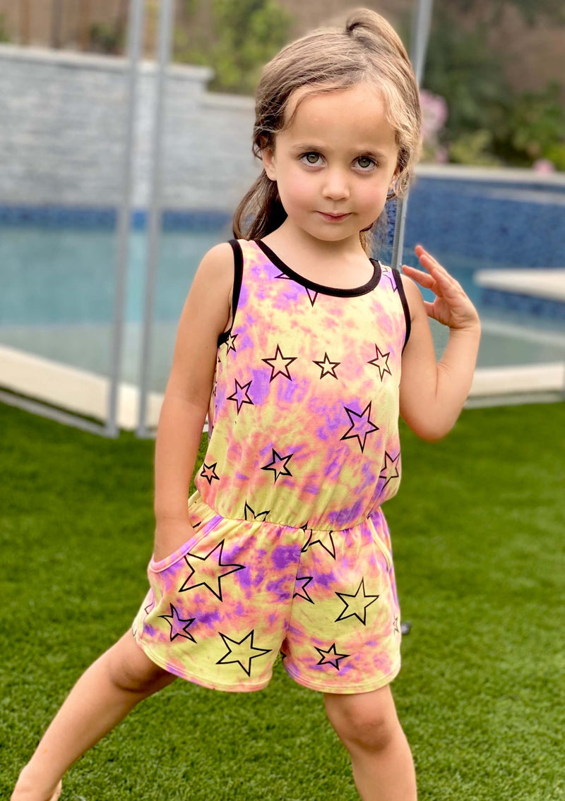 Young girl wearing a pink and yellow romper