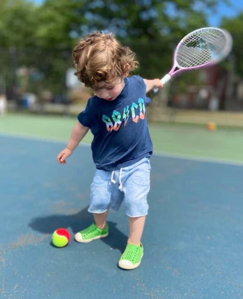 Baby boy holding a tennis racket
