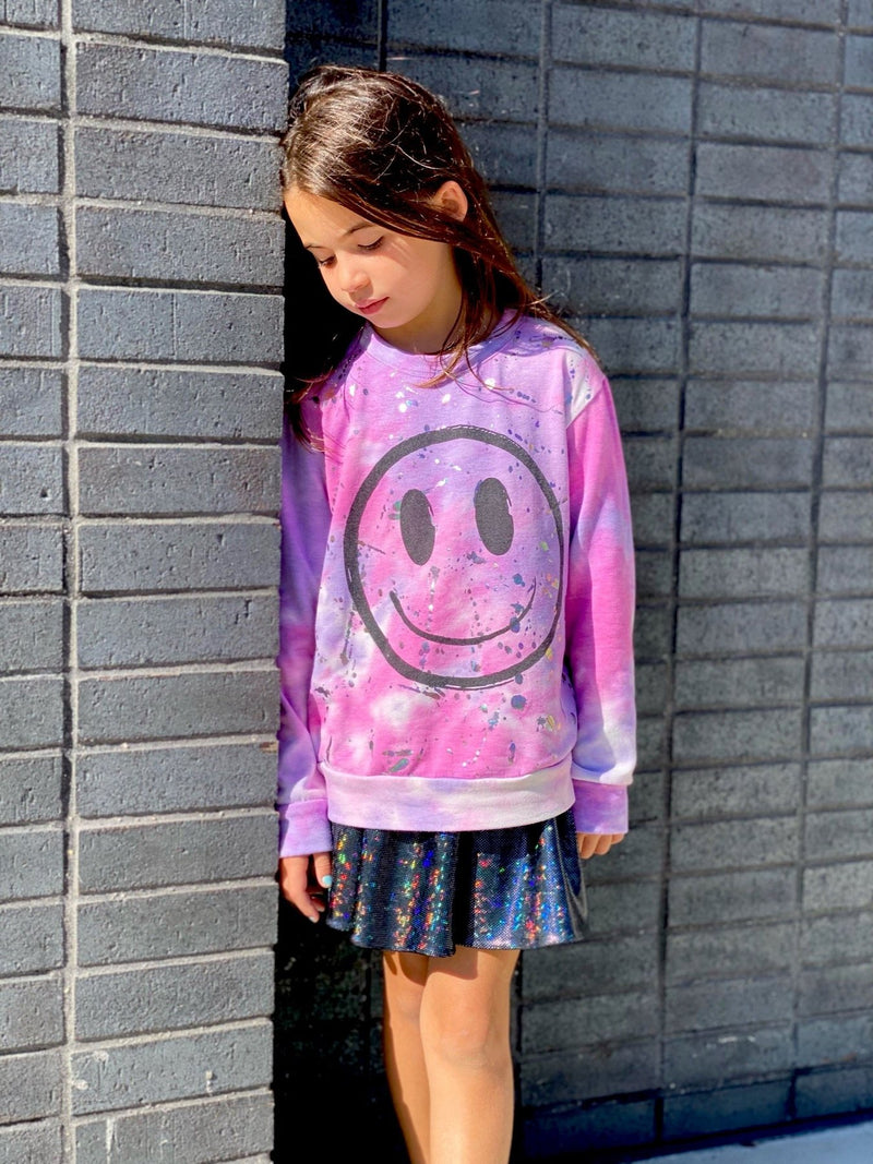 Little girl wearing pink long sleeve shirt.